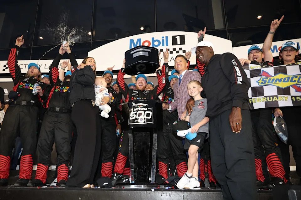 Tyler Reddick, driver of the #45 Chumba Casino Toyota, lifts the Harley J. Earl Trophy in victory lane after winning the NASCAR Cup Series Daytona 500 at Daytona International Speedway on February 15, 2026. Getty Images