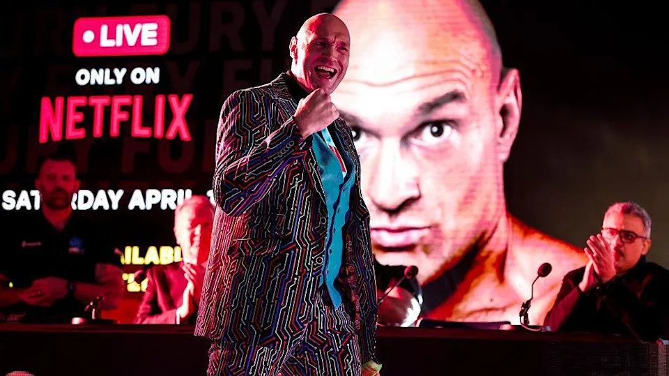 Tyson Fury pumps his first as he makes his way to the stage