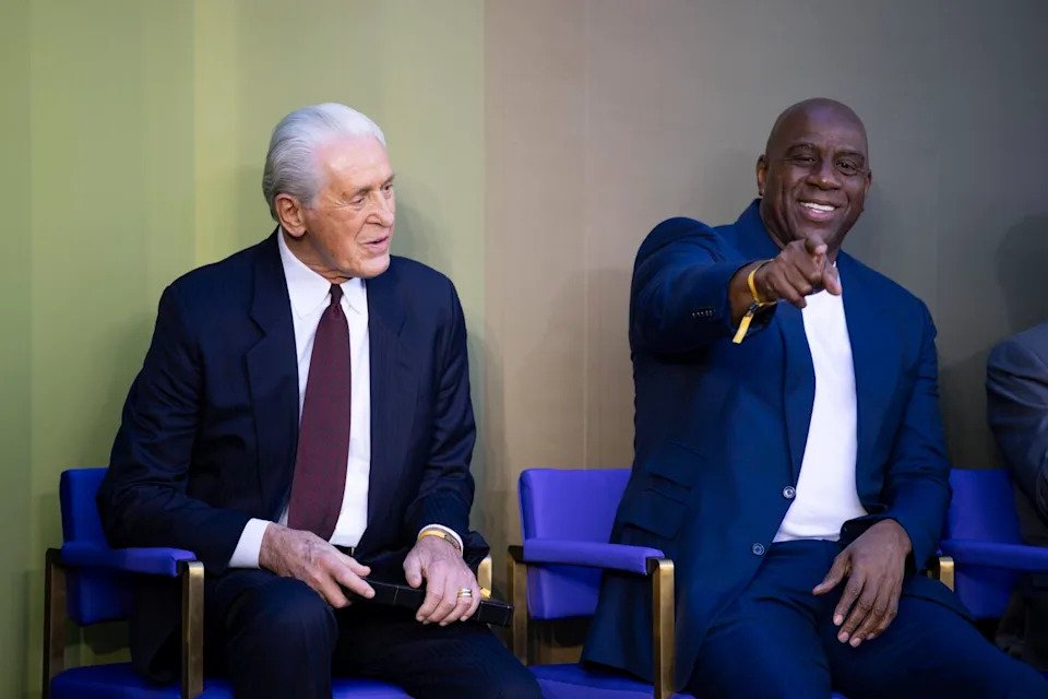 Pat Riley speaks with Magic Johnson during Riley's statue unveiling at Crypto.com Arena on Sunday.