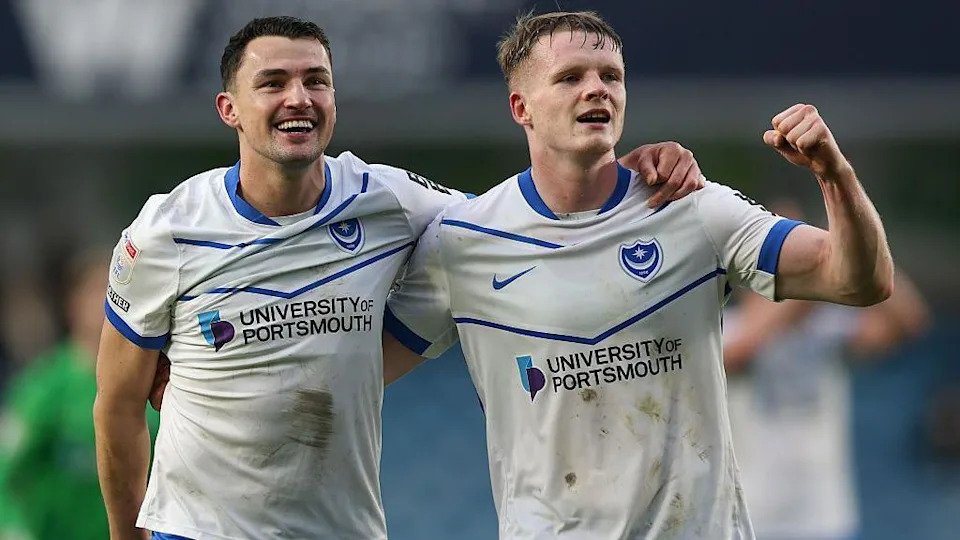 Regan Poole and Terry Devlin celebrate after Portsmouth beat Millwall