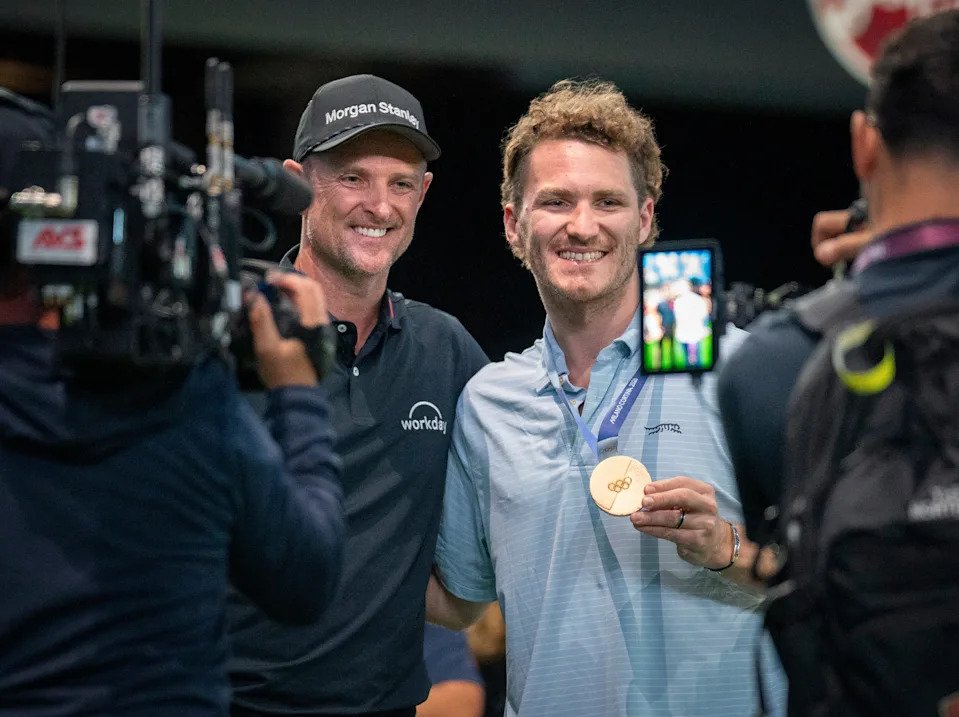 Florida Panthers Matthew Tkachuk shows off his Olympic gold medal with Justin Rose of Los Angeles Golf Club before theTGL finals at SoFi Center on March 23, 2026, in Palm Beach Gardens, Florida.