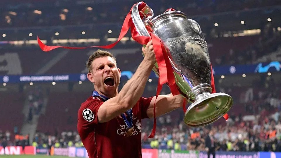 James Milner hoists aloft the Champions League trophy - 2019.