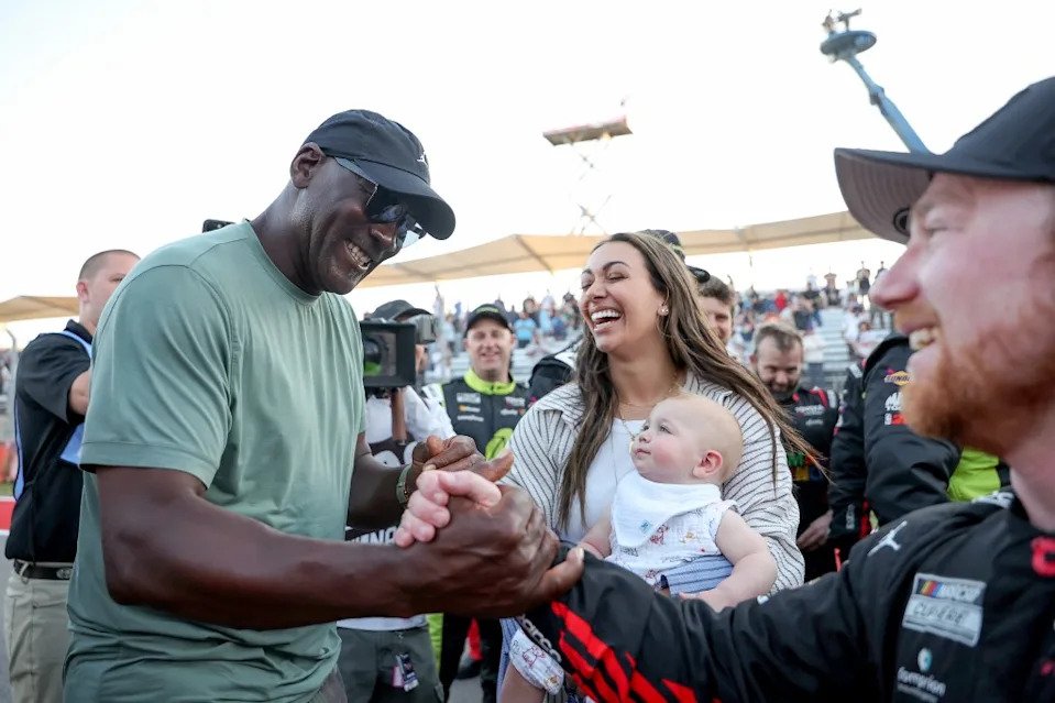 NBA Hall of Famer Michael Jordan and NASCAR driver Tyler Reddick celebrate with Reddick’s wife and baby after his victory. Getty Images