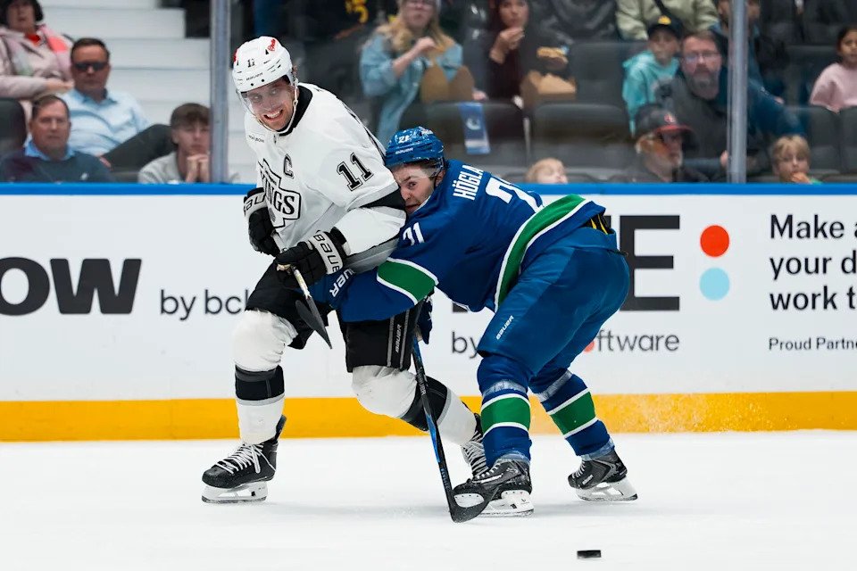 Mar 26, 2026; Vancouver, British Columbia, CAN; Vancouver Canucks forward Nils Hoglander (21) checks Los Angeles Kings forward Anze Kopitar (11) in the first period at Rogers Arena. Mandatory Credit: Bob Frid-Imagn Images