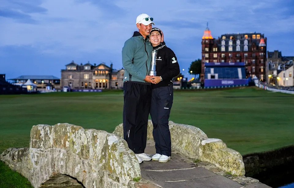Lydia Ko of New Zealand and her husband Jun Chung with the AIG Women's Open Championship trophy on the Swilcan Bridge during day four of the 2024 AIG Women's Open Championship at The Old Course, on August 25, 2024, in St. Andrews, Scotland.