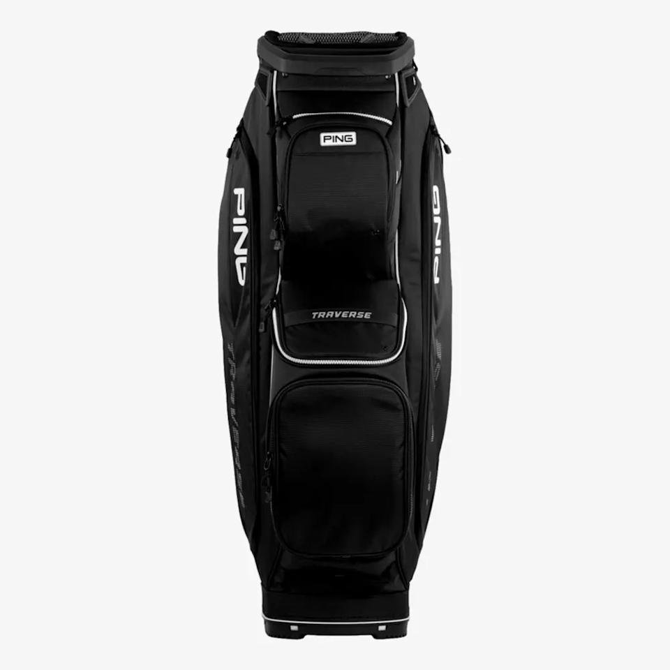 A black PING Traverse golf bag, one of the best golf bags 2026, stands upright against a plain white background. It features multiple zippered pockets and distinctive white PING branding on the sides.