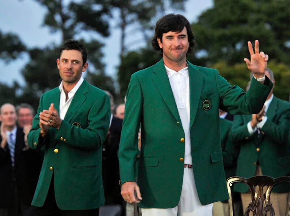 Apr 8, 2012; Augusta, GA, USA; Bubba Watson (right) reacts after being presented with the green Masters champion jacket from 2011 winner Charl Schwartzel (left) after the 2012 The Masters golf tournament at Augusta National Golf Club. Mandatory Credit: Jack Gruber-USA TODAY Sports