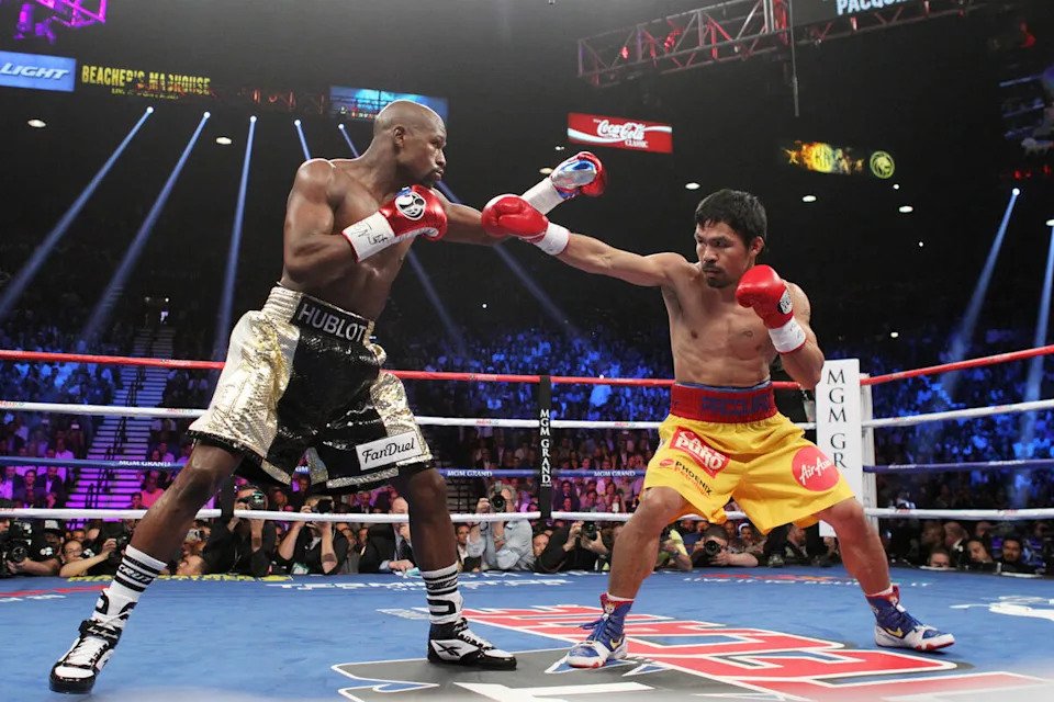 Manny Pacquiao and Floyd Mayweather Jr. trade punches during their welterweight unification boxing match at the MGM Grand Garden Arena in Las Vegas, Nevada on Saturday, May 2, 2015. (Sam Morris/Las Vegas Review-Journal/Tribune News Service via Getty Images)