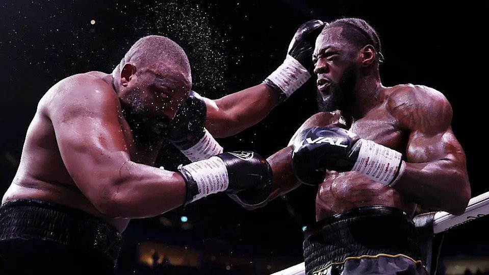 Deontay Wilder and Derek Chisora exchange punches during their heavyweight bout
