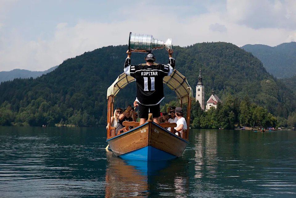 Kings captain Anze Kopitar raises the Stanley Cup as he floats across Lake Bled in Slovenia with family and friends in 2012.
