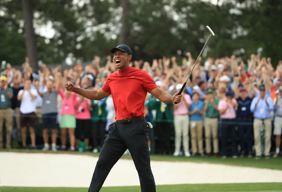 Tiger Woods (L) of the United States celebrates on the 18th green after winning the Masters at Augusta National Golf Club on April 14, 2019 in Augusta, Georgia.