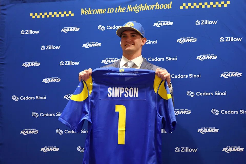 Los Angeles Rams first-round draft pick Ty Simpson poses with his jersey during a press conference at Code Next at Hollywood Park.