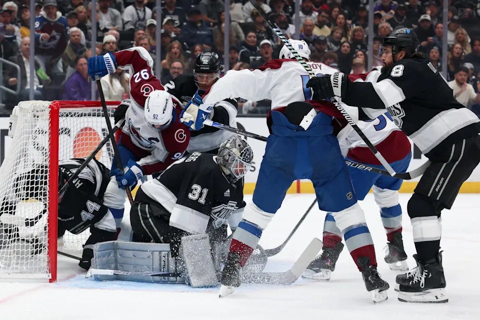Kings goalie Anton Forsberg covers the puck as Colorado left wing Gabriel Landeskog battles for it in the second period.