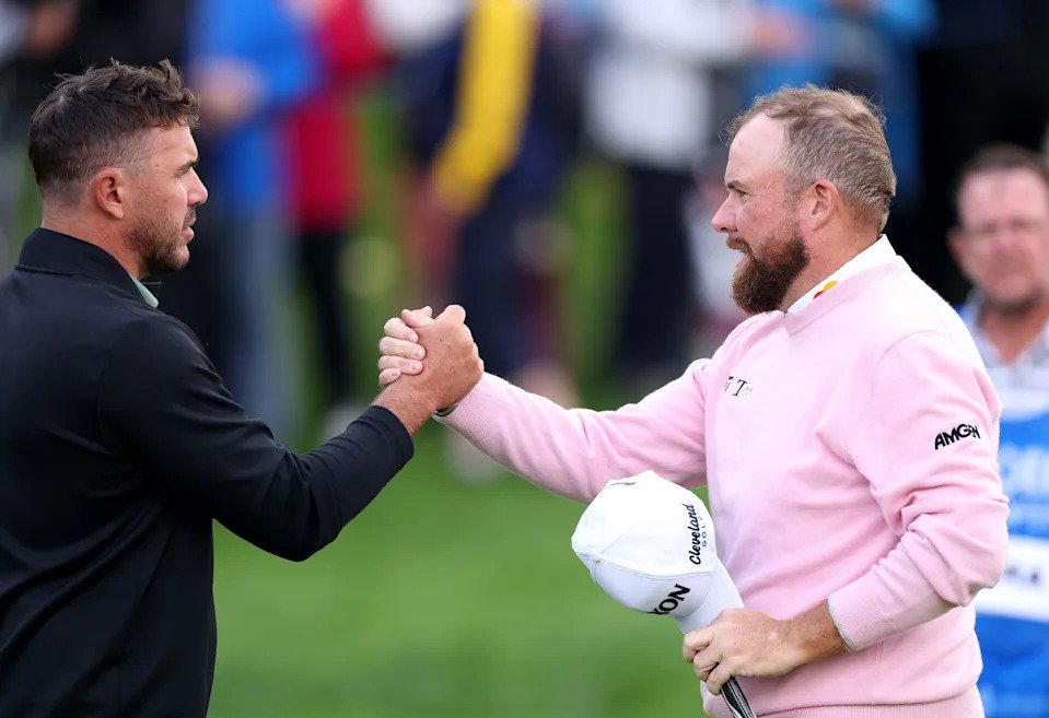Brooks Koepka of the United States and Shane Lowry of Ireland shake hands after finishing their round on the 9th green on day one of the Amgen Irish Open 2025 at The K Club on September 04, 2025 in Straffan, Ireland.
