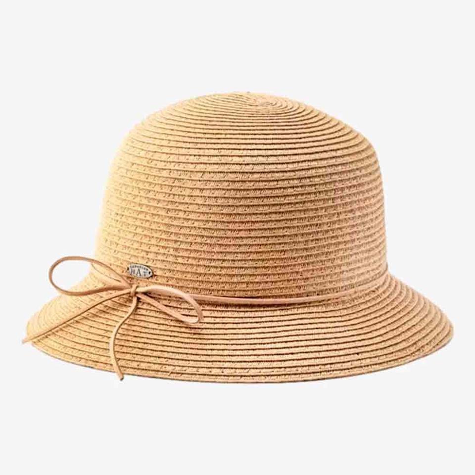 A light brown, woven straw cloche hat with a round crown and narrow brim, featuring a thin decorative bow and small metal accent—perfect as a thoughtful Mother's Day gift.