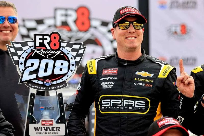 HAMPTON, GA – FEBRUARY 22: Kyle Busch 7 Spire Motorsports Gainbridge Chevrolet celebrates in Victory Lane with the trophy and his team after winning the NASCAR, Motorsport, USA Craftsman Truck Series FR8 208 race on February 22, 2025 at the Atlanta Motor Speedway in Hampton, Georgia. Photo by David J. Griffin/Icon Sportswire AUTO: FEB 22 NASCAR Craftsman Truck Series FR8 208 EDITORIAL USE ONLY Icon953250222055