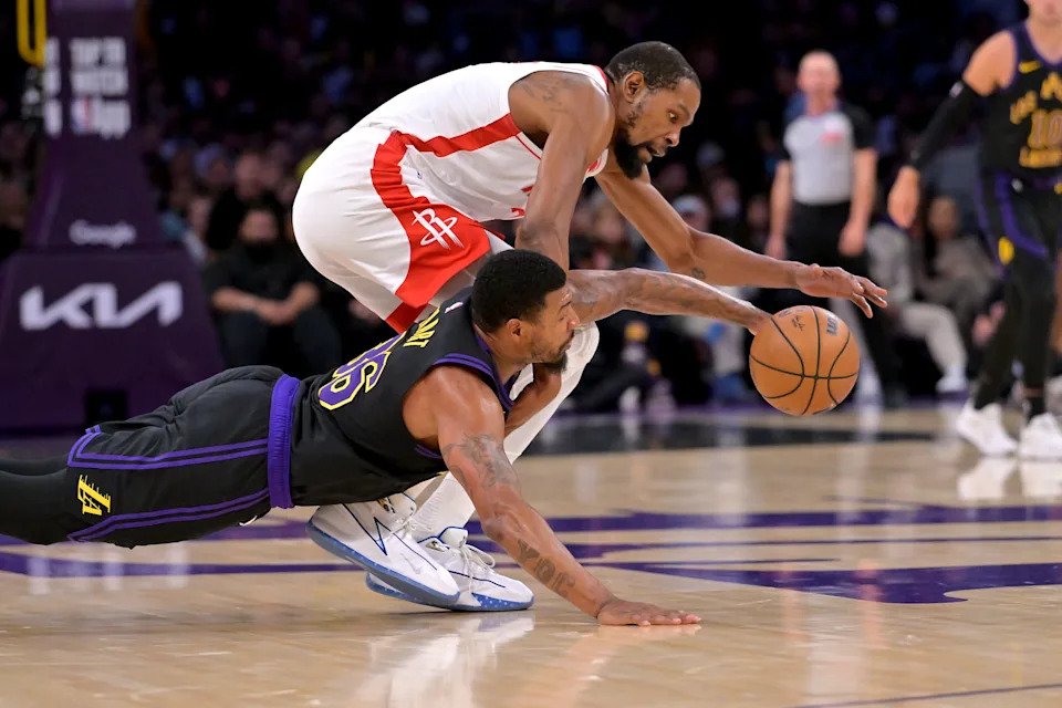 Los Angeles Lakers guard Marcus Smart (36) and Houston Rockets forward Kevin Durant (7) chase down a loose ball in the first half of Game 2 of the first round of the 2026 NBA Playoffs at Crypto.com Arena.