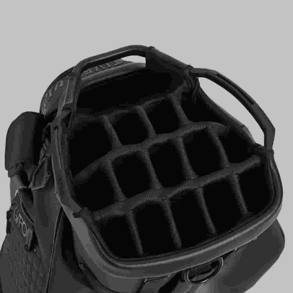 Top-down view of one of the best golf bags 2026, featuring multiple padded compartments for organizing clubs, sturdy handles, and visible stitching details against a plain gray background.