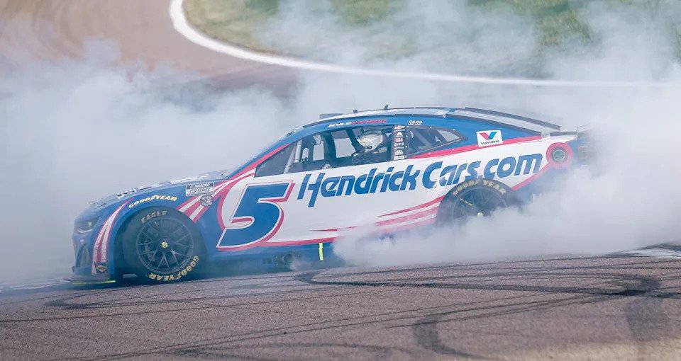 Kyle Larson performs a burnout after winning at Kansas in 2025.