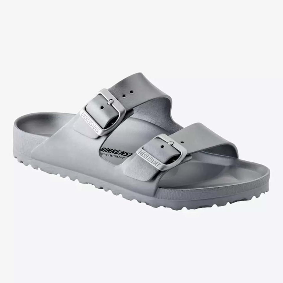 A gray sandal with two adjustable buckle straps and a textured sole, displayed on a white background. The Birkenstock logo is printed on the footbed—perfect for Mother’s Day gifts or as one of the best gifts under $50.