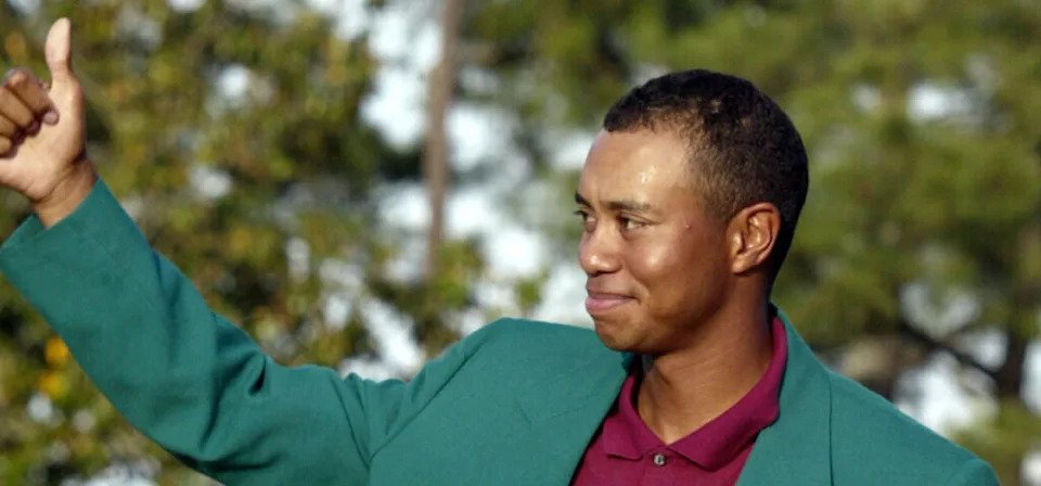 April 14, 2002; Augusta, GA, USA; Tiger Woods gives a thumbs up after receiving the green jacket for winning the 2002 Masters. Mandatory Credit: Tim Dillon/USA TODAY