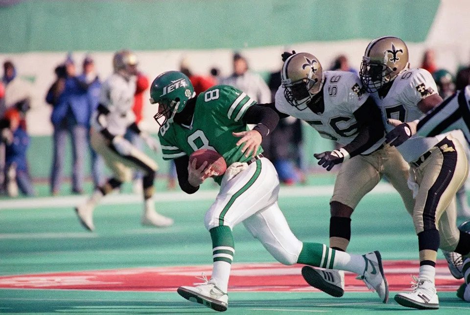 New York Jets quarterback Browning Nagle (8) runs away from New Orleans Saints Pat Swilling (56) and Rickey Jackson (57) during the first quarter of their game at Giants Stadium in East Rutherford, N.J. on Saturday, Dec. 26, 1992. AP