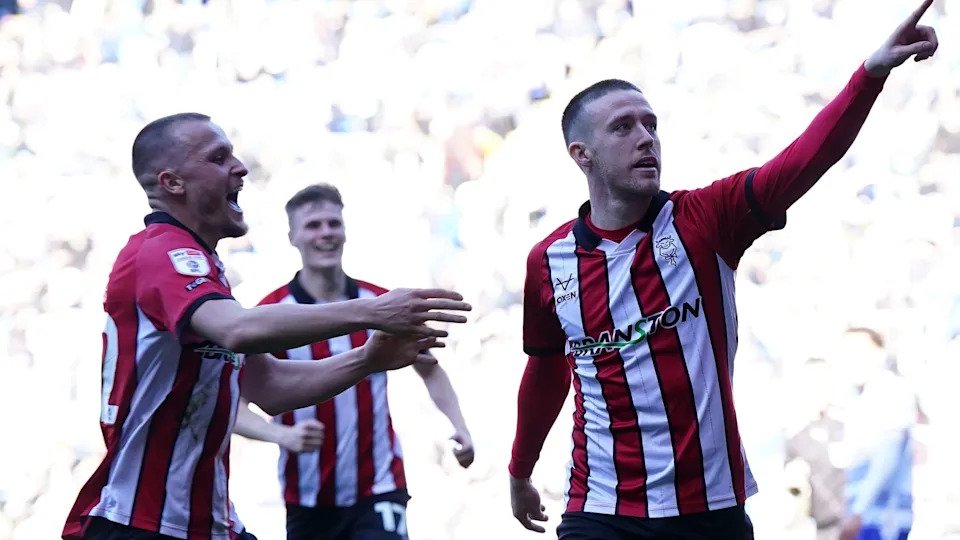 Jack Moylan (right) celebrates scoring for Lincoln in their promotion-clinching game against Reading