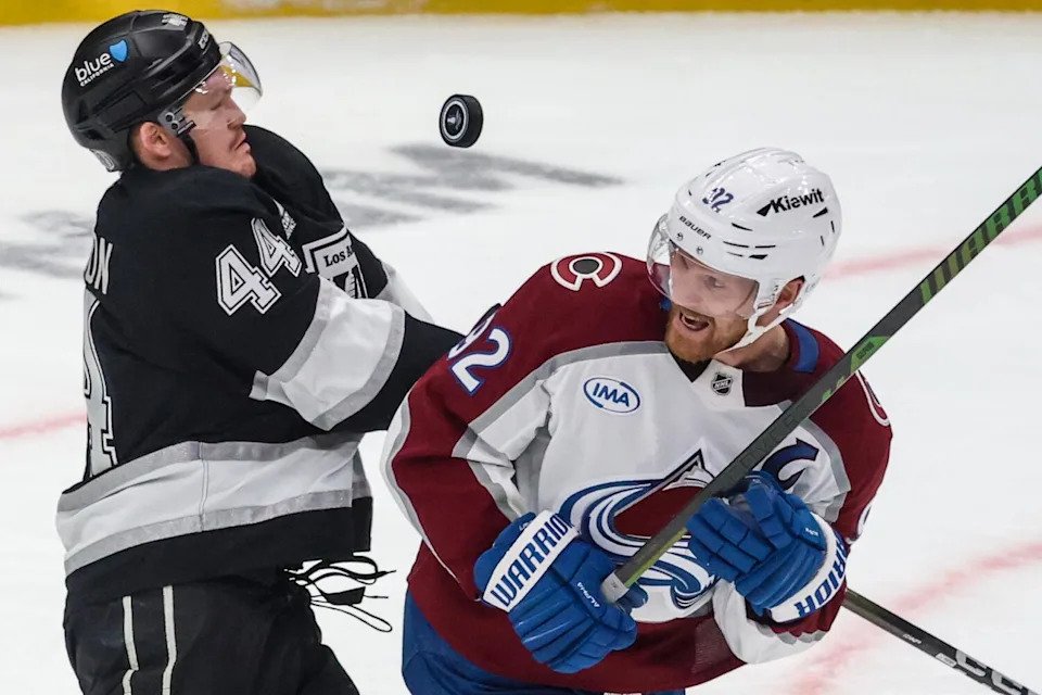 Kings defenseman Mikey Anderson, left, battles Colorado Avalanche left wing Gabriel Landeskog.