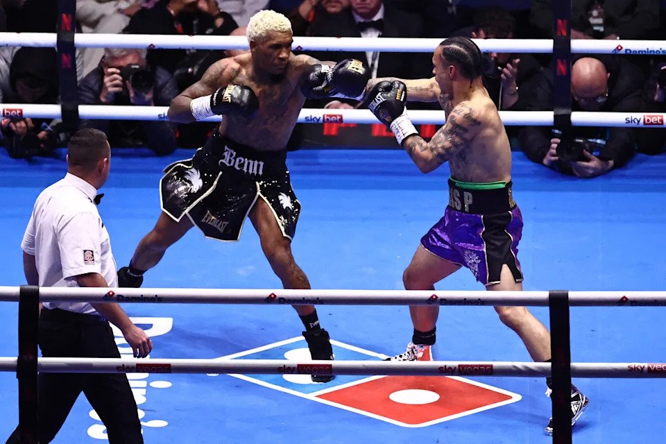 British boxer Conor Benn (L) and US boxer Regis Prograis (R) throw punches during their super-welterweight contest at the Tottenham Hotspur stadium in London on April 11, 2026. (Photo by Henry NICHOLLS / AFP via Getty Images)